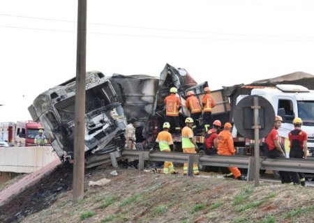 BR-163: colisão frontal sobre viaduto 'explode' caminhão, mata 1 e deixa outro preso nas ferragens